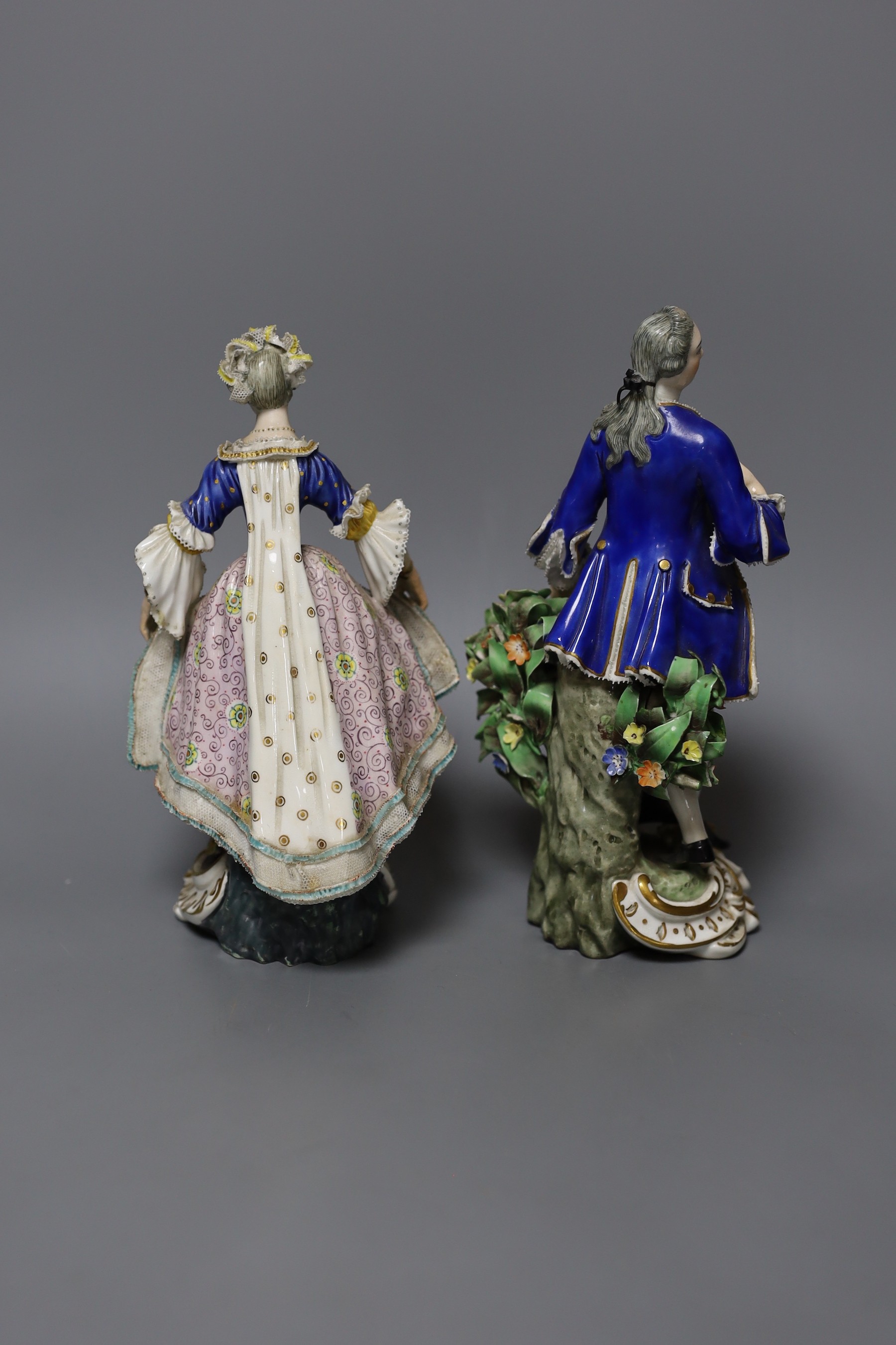 A pair of Derby figures of dancers, both elegantly dressed, incised N317 and blue crossed swords mark to base, tallest 19cm